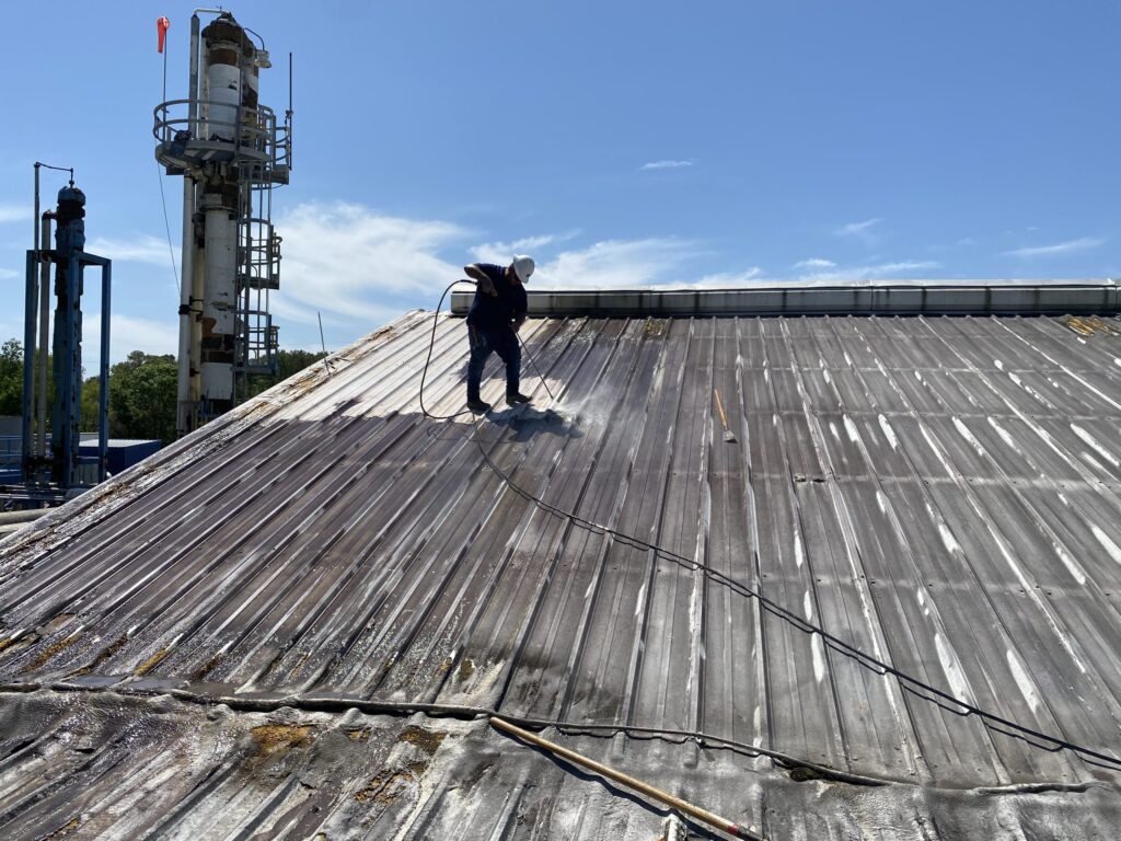 a man cleaning a roof